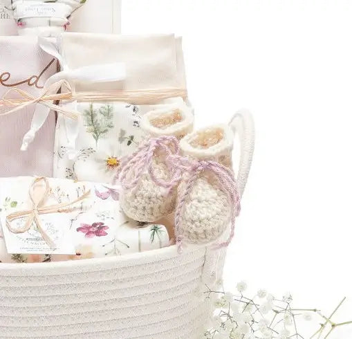 Organic cotton baby gift basket with OEKO-TEX certified swaddle and newborn essentials