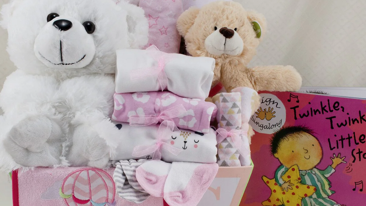 Curated newborn baby gift basket with personalized keepsakes and soft essentials
