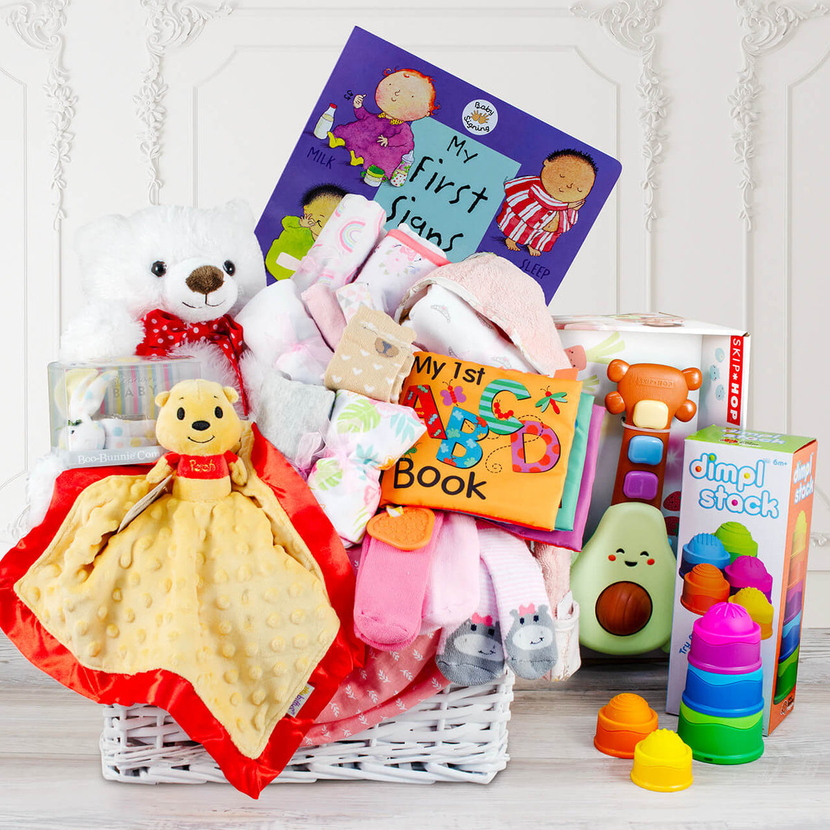 Organic newborn baby clothes set with onesie, booties, pants, hat, and burp cloth