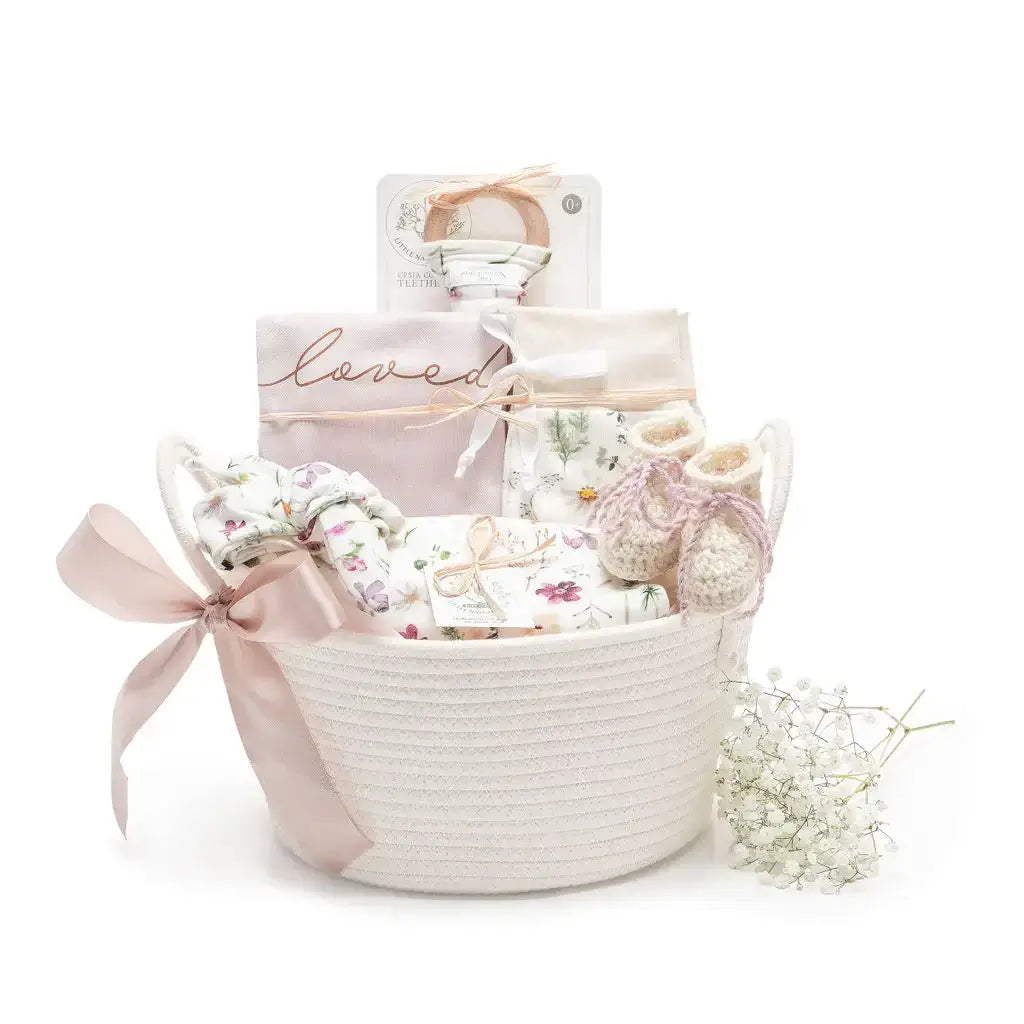 Organic baby girl gift basket with GOTS-certified cotton layette set and newborn clothes
