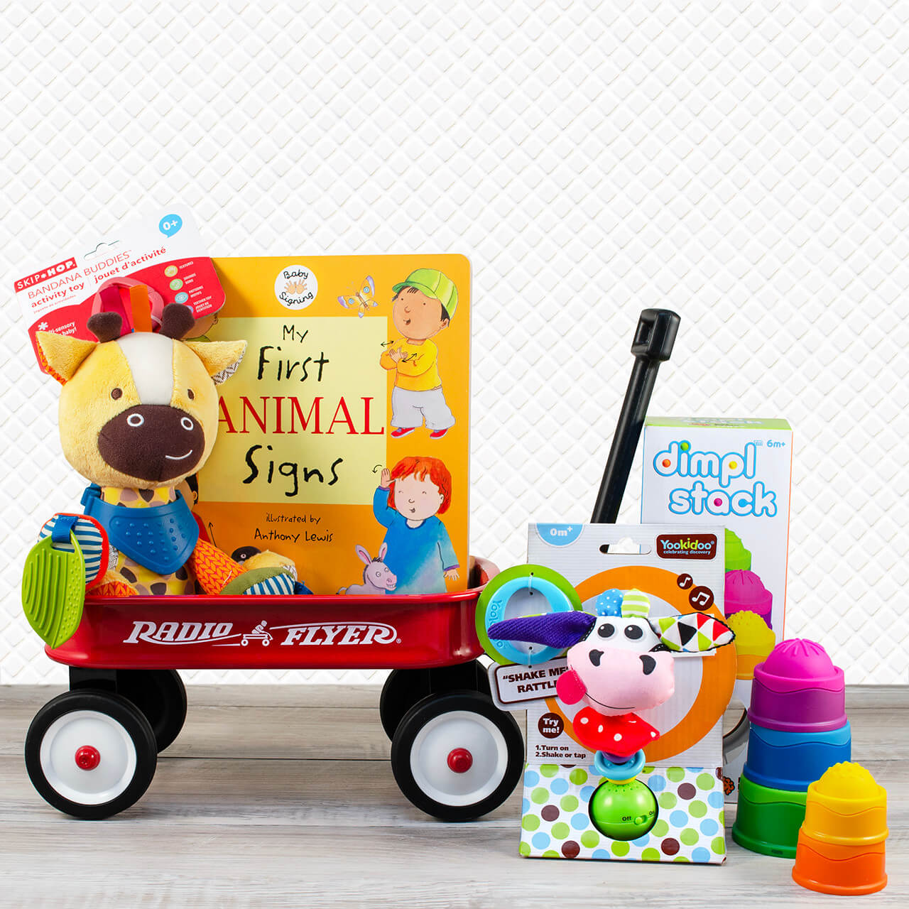 Ready, Set, Play! Red Wagon Gift Set with Radio Flyer wagon, soft activity toy, stacking toy, rattle, and board book
