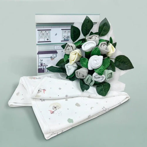 Baby gift set with soft muslin swaddle blanket and baby clothing bouquet in neutral grey and white tones, presented with gift box