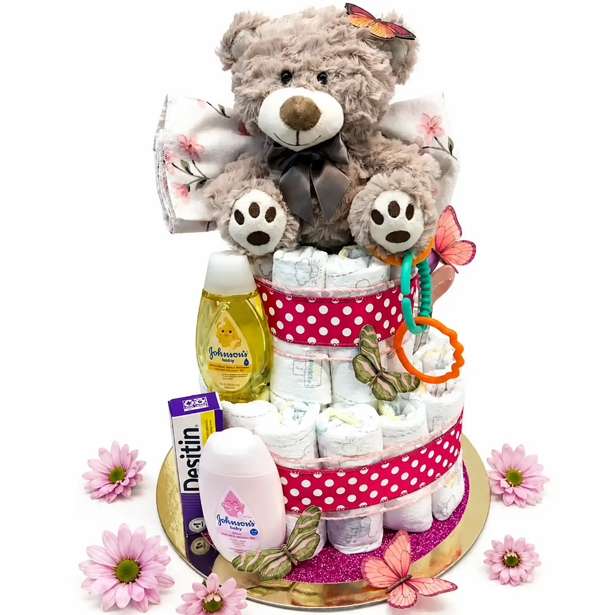 Two-tier baby shower diaper cake with gray plush teddy bear, Johnson's baby shampoo and lotion, Desitin diaper cream, teething rings, pink polka dot ribbon trim, butterfly decorations, and pink daisy flowers