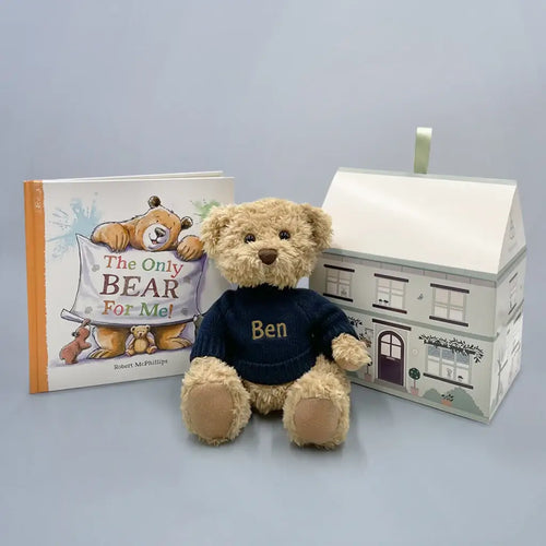 Tan plush teddy bear in a navy embroidered knit sweater with the name "Ben" beside "The Only Bear For Me!" hardcover picture book and a house-shaped illustrated gift box — personalized sibling bear and book gift set.