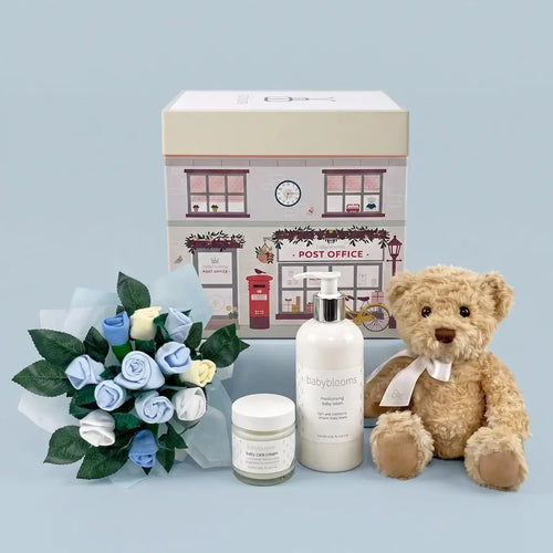Luxury newborn gift box for baby boys with plush bear, bouquet, baby lotion, and cream — beautifully packaged and ready to give