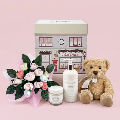 Luxury newborn gift box for baby girls with plush bear, bouquet, baby lotion, and cream — beautifully packaged and ready to give