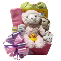 Sweet-Baby-Girl-Basket contains a plush pink teddy bear, onesie, blanket, rattle, bunny booties and more.
