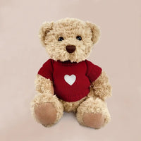 Valentine's Day teddy bear in red knitted sweater with heart motif, gift-boxed baby keepsake safe from birth
