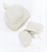 Handmade natural baby alpaca knotted cap and booties, flat lay, newborn size, gender neutral