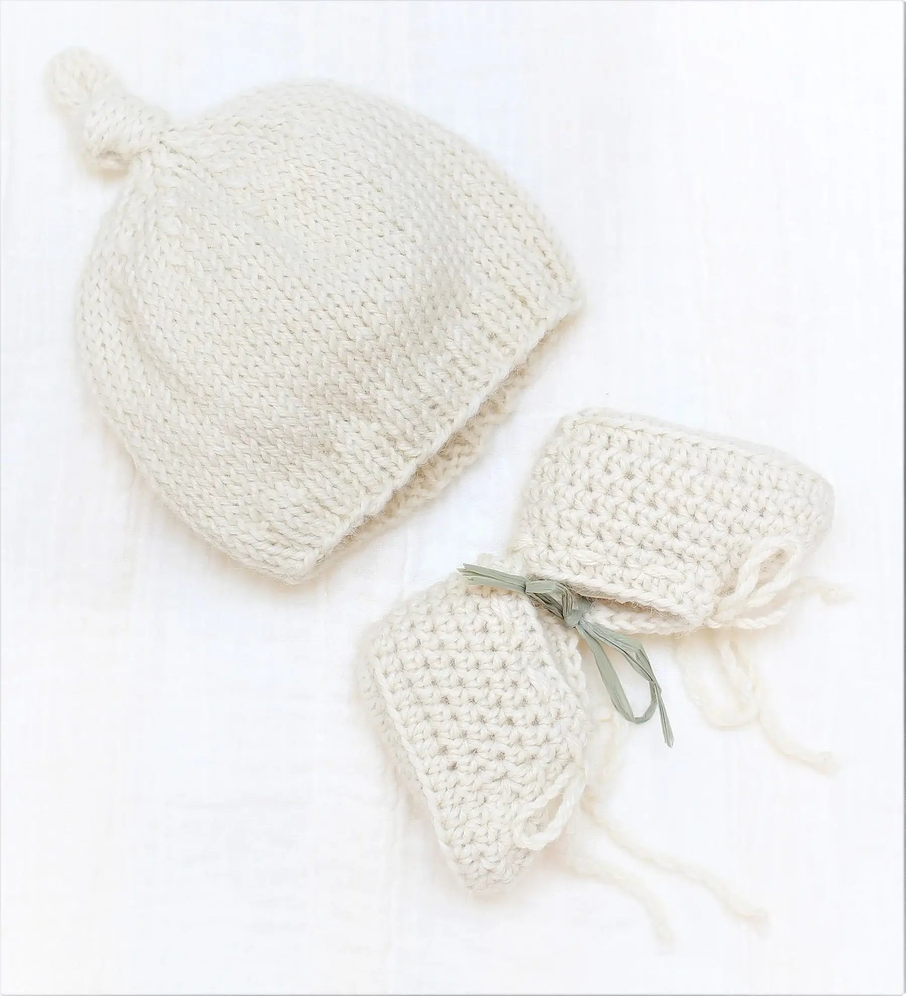 Handmade natural baby alpaca knotted cap and booties, flat lay, newborn size, gender neutral