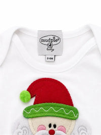 Close up showing Mud Pie My First Christmas white cotton baby sleeper gown with felt Santa applique label and size