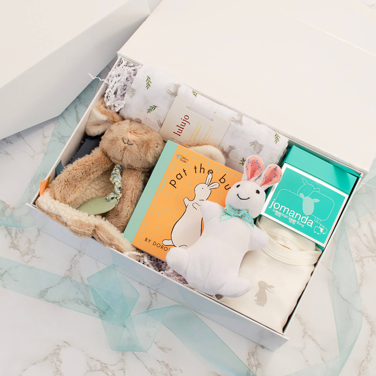 The Little Bunny Welcome Set displayed in a collapsible magnetic gift box, ready to give