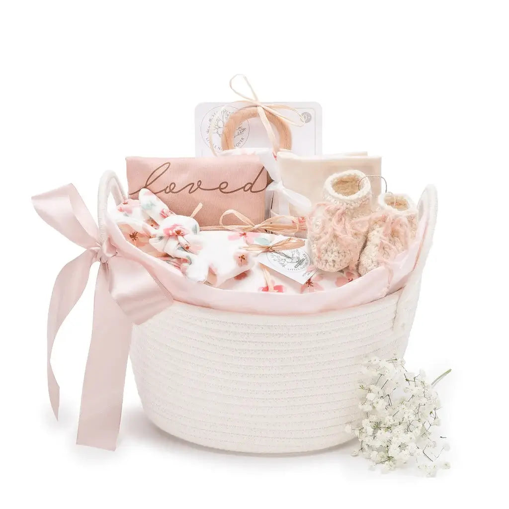 Mauve Meadow organic baby girl gift basket with layette set in white rope basket