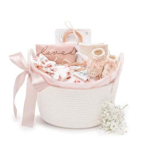 Mauve Meadow organic baby girl gift basket with layette set in white rope basket