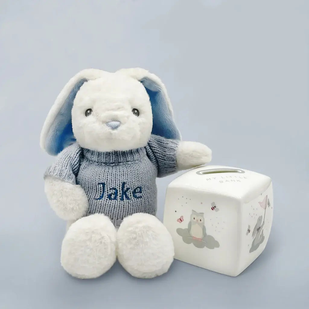 Personalized blue eco bunny in blue knitted jumper with bone china money box keepsake gift set for baby boys, presented in an illustrated gift box with satin ribbon