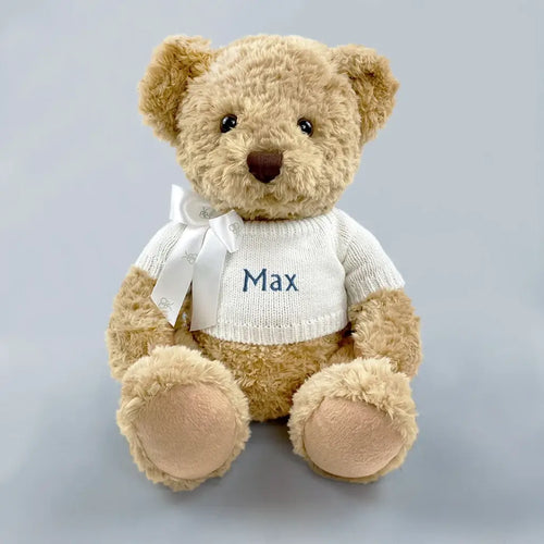 Personalized baby boy teddy bear keepsake gift in white knit sweater with blue embroidered name and white ribbon bow