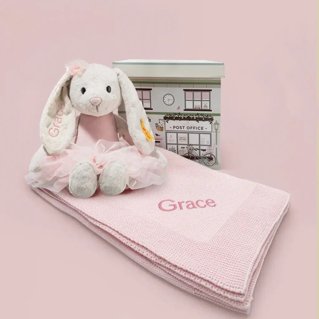 Personalized Steiff Hoppie Ballet Bunny in pink tutu with personalized pink knitted baby blanket and illustrated gift box