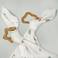 Twin wooden baby teether gift set with star and cloud shaped teethers tied with whimsical print muslin cloths