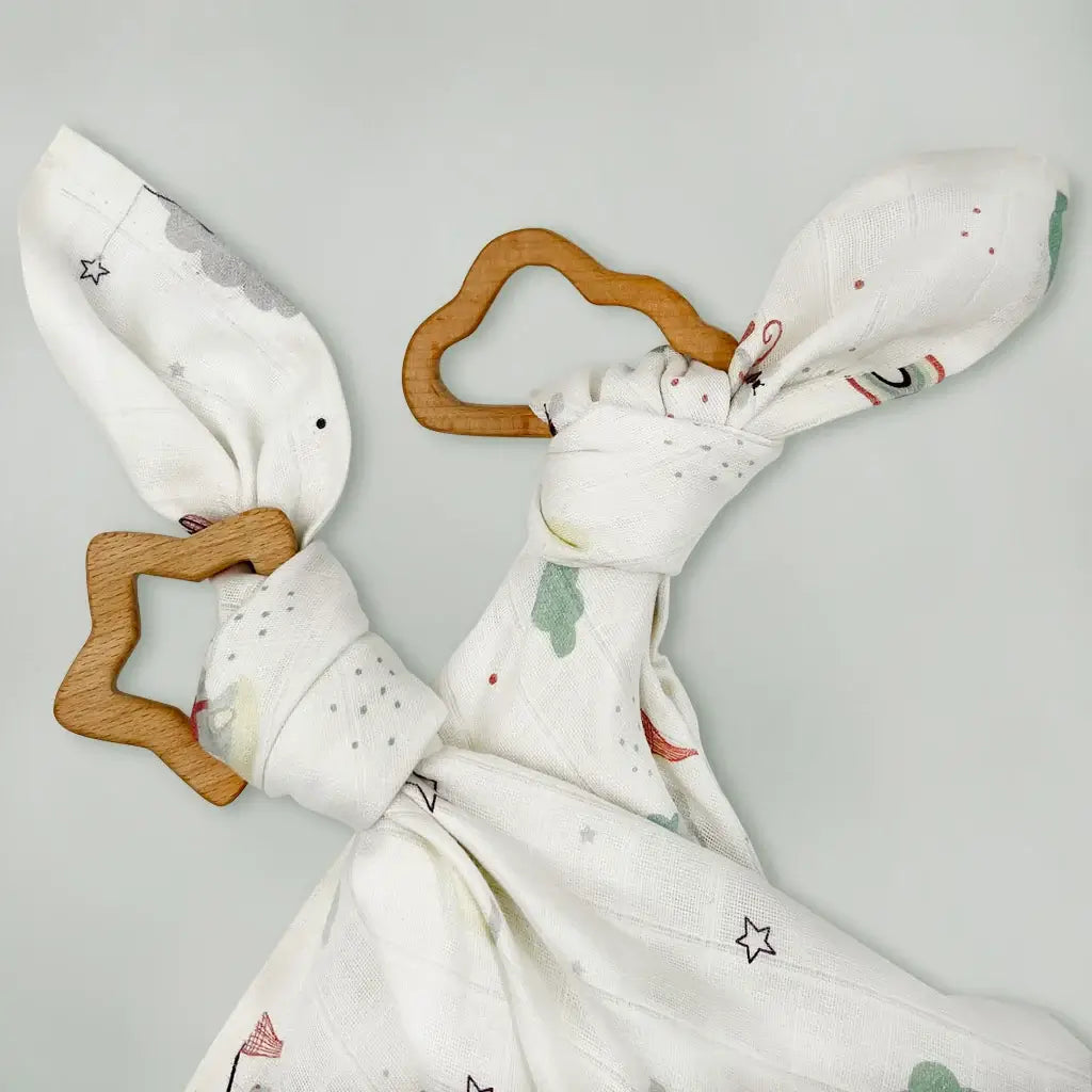 Twin wooden baby teether gift set with star and cloud shaped teethers tied with whimsical print muslin cloths