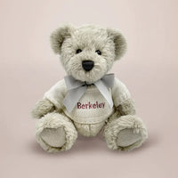 Personalized teddy bear in a white knitted sweater embroidered with baby's name in red